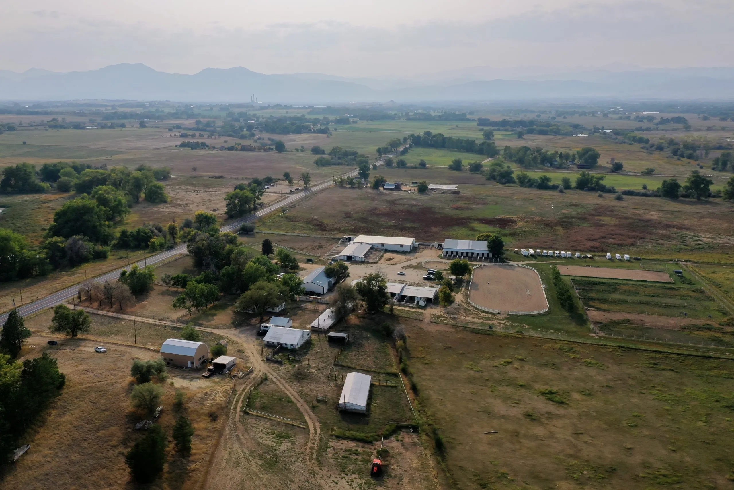 Aerial view of White Dog Farm from the east with the Flatirons beyond